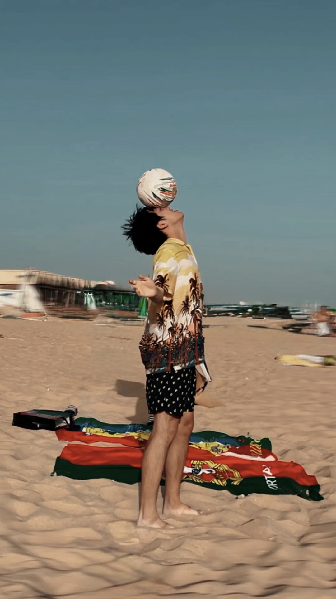 Ruijia Zhang balancing a football on the beach